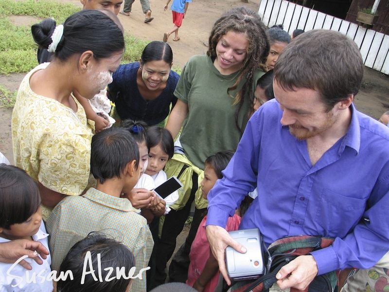 Ani DiFranco and Damien Rice share polaroid photos with school children in the Karen State of Burma